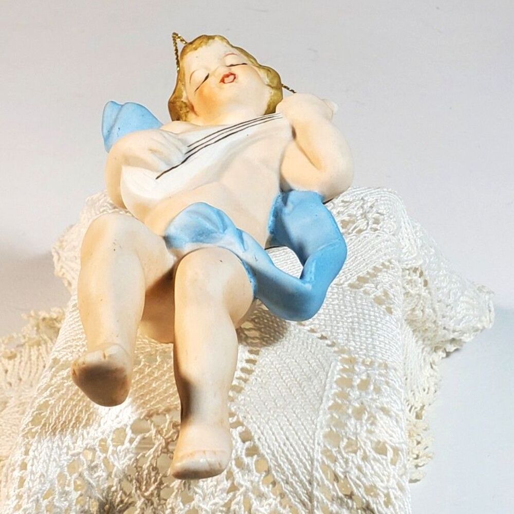 Bisque Angel Playing a White Mandolin with a Blue Ribbon wrapped around his Body